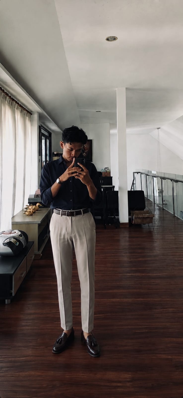 Ilyas Muzakki in a black shirt and light trousers